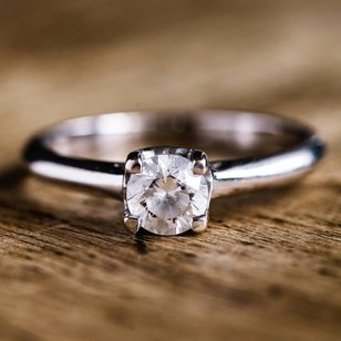 Simple diamond solitaire on a wooden surface