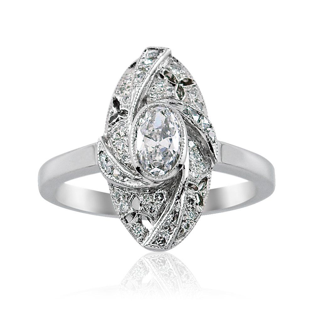 Vintage platinum diamond cluster ring with an oval centre