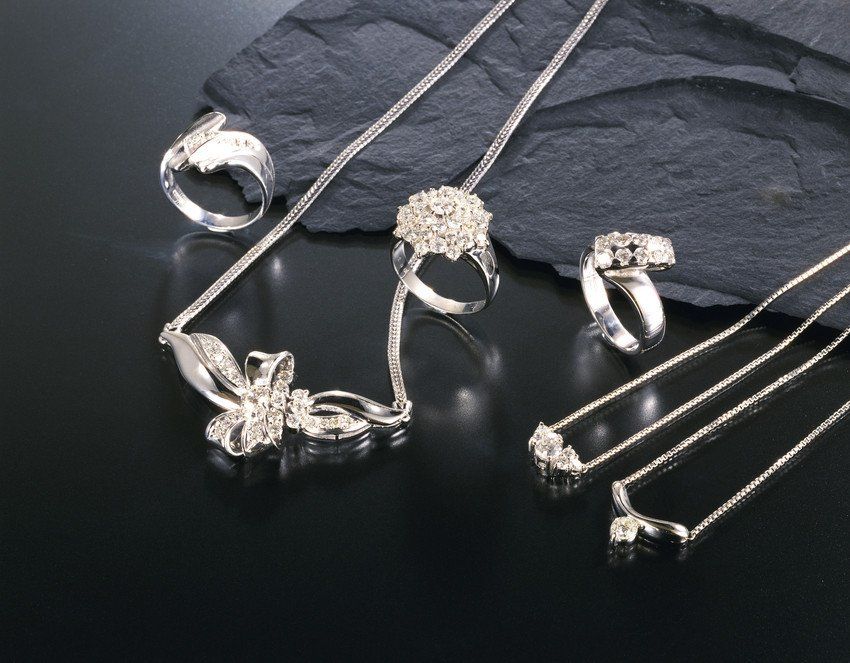Diamond necklaces and rings arranged on slate